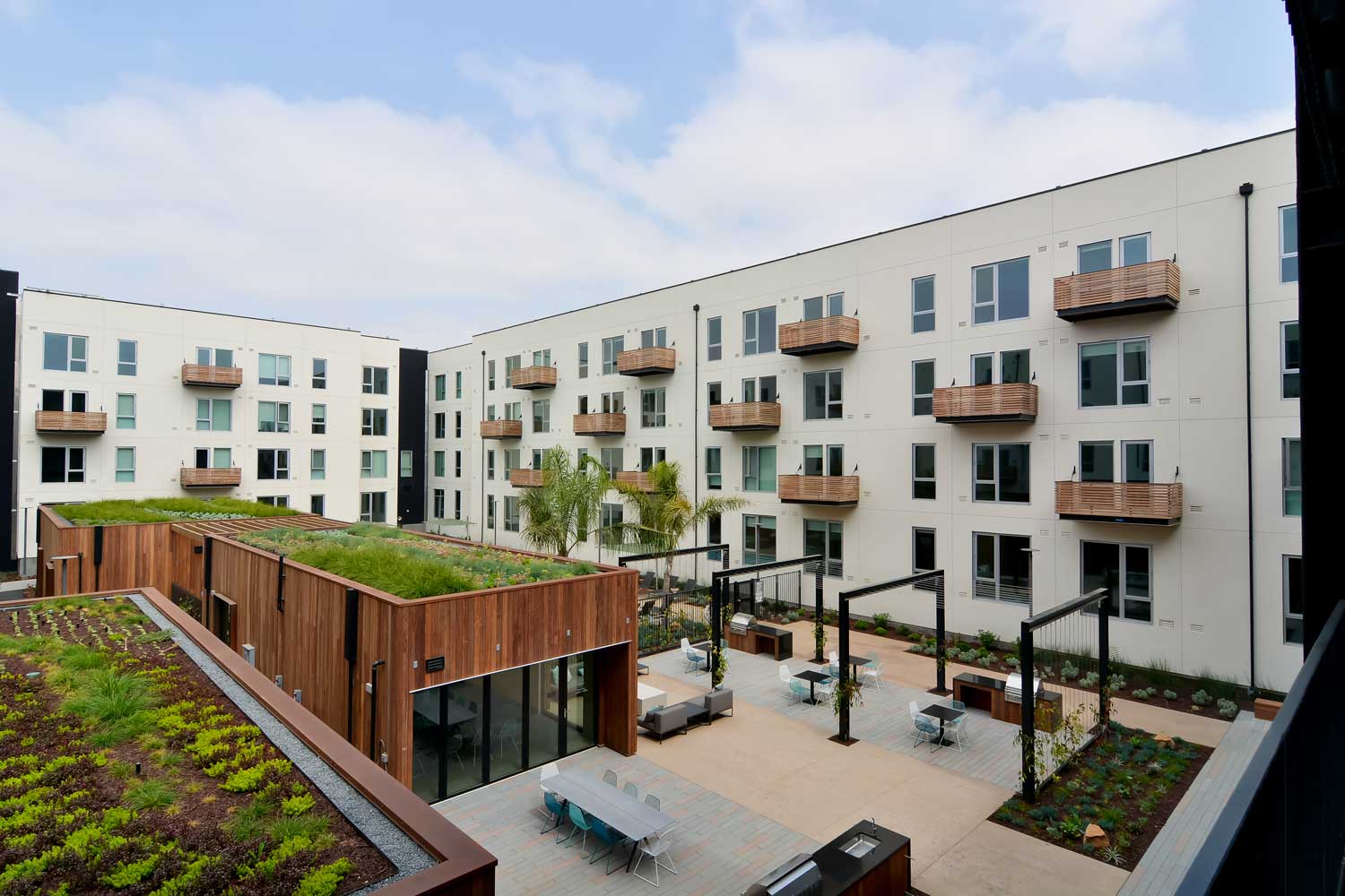 Union City California Apartments-The Union Flats Building Exterior with Lush Landscape and BBQ Grills